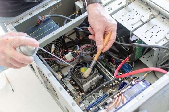 Técnico limpiando el interior de una PC de escritorio